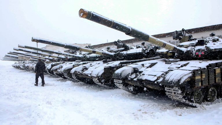 A service member walks past tanks of a mechanized brigade of the Ukrainian Armed Forces during military exercises outside Kharkiv, Ukraine January 31, 2022. REUTERS/Vyacheslav Madiyevskyy
