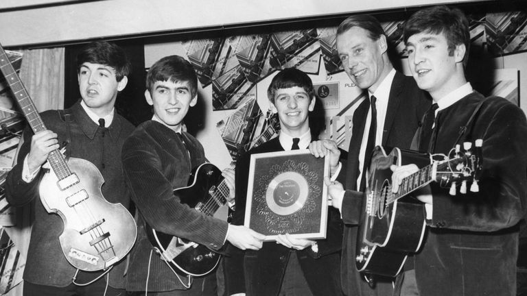 Paul McCartney, George Harrison, Ringo Starr and John Lennon receive a silver disc from George Martin in 1963. Pic: Keystone/Shutterstock

4 Aug 1963