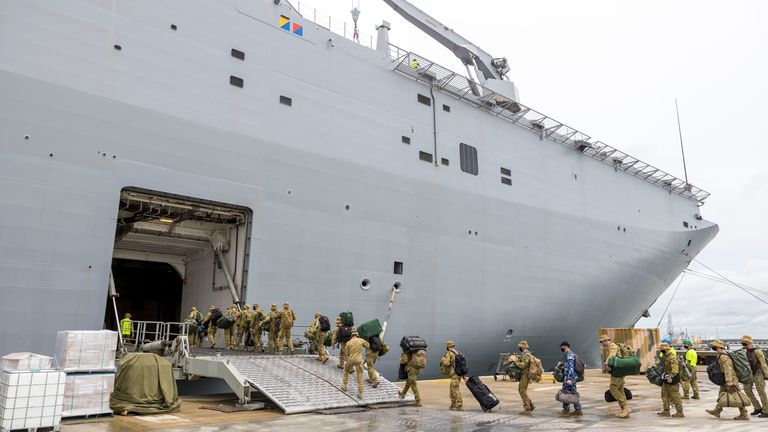Soldiers board HMAS Adelaide at the Port of Brisbane before departing for Tonga on Thursday. Pic: CPL Robert Whitmore/Australia Defence Force via AP