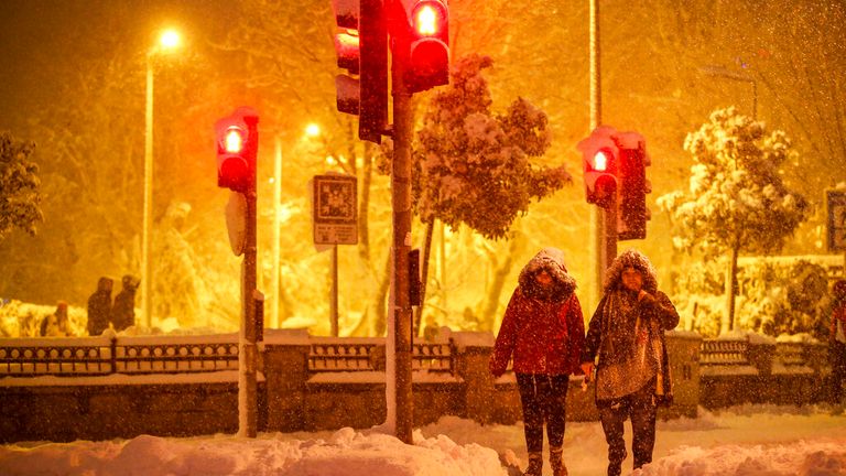 People head out in the snow in Istanbul after the storm caused widespread chaos