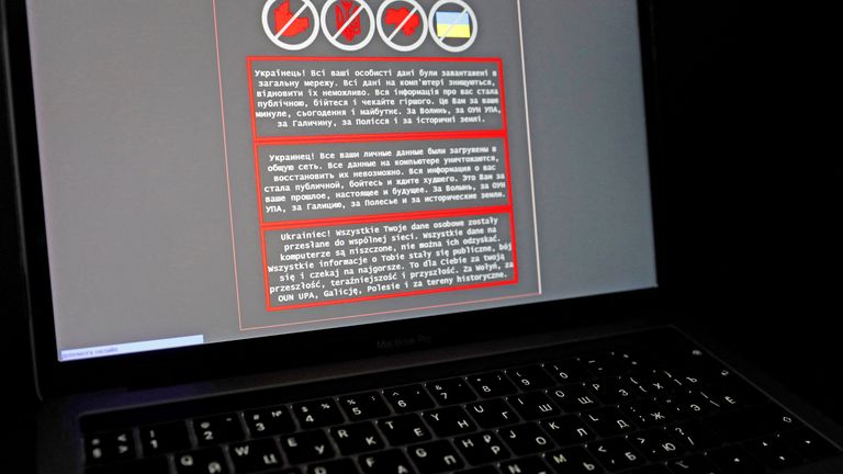 FILE PHOTO: A laptop screen displays a warning message in Ukrainian, Russian and Polish, that appeared on the official website of the Ukrainian Foreign Ministry after a cyberattack, in this illustration taken January 14, 2022. REUTERS/Valentyn Ogirenko/Illustration/File Photo
