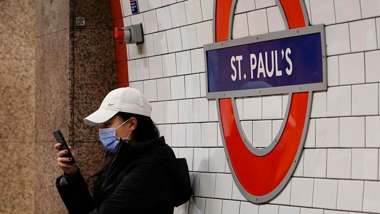 A woman wears a mask as she sits at St. Paul&#39;s Underground station, in London, Thursday, Dec. 16, 2021.  
PIC:AP