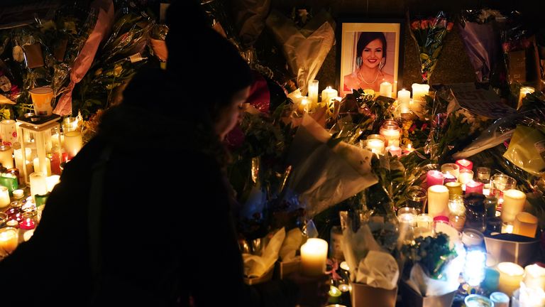 A photograph of Ashling Murphy among flowers and candles at a make-shift shrine during a vigil in her memory at Leinster House, Dublin, following her murder when she was attacked while she was jogging along the Grand Canal in Tullamore, County Offaly, on Wednesday. Picture date: Friday January 14, 2022