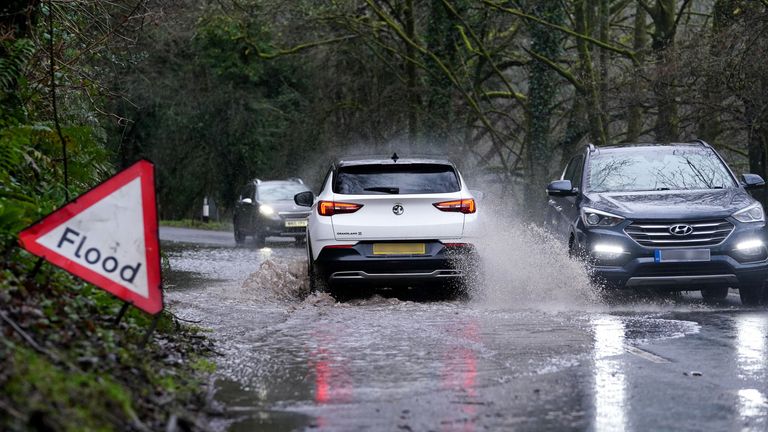 Cars drive through floodwaters between Monmouth and Tintern in the Wye Valley in Wales on 27 December.
