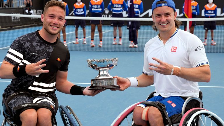 Alfie Hewett, left, and Gordon Reid of Britain pose with their trophy after defeating Shingo Kunieda of Japan and Gustavo Fernandez of Argentina in the men&#39;s wheelchair doubles final at the Australian Open tennis championships in Melbourne, Australia, Wednesday, Jan. 26, 2022. (AP Photo/Simon Baker)