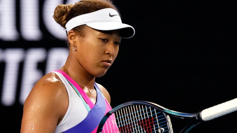 Naomi Osaka of Japan bounces her racket in frustration during her third Rond match against Amanda Anisimova of the U.S. at the Australian Open tennis championships in Melbourne, Australia, Friday, Jan. 21, 2022. (AP Photo/Simon Baker)
