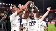 Boreham Wood&#39;s Adrian Clifton (L) and Tyrone Marsh celebrate with the fans while holding a miniature replica FA Cup