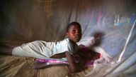 Sulay Momoh Jongo, 7, is seen inside a mosquito net in a mud hut in Mallay village, southern Sierra Leone, on April 8, 2008