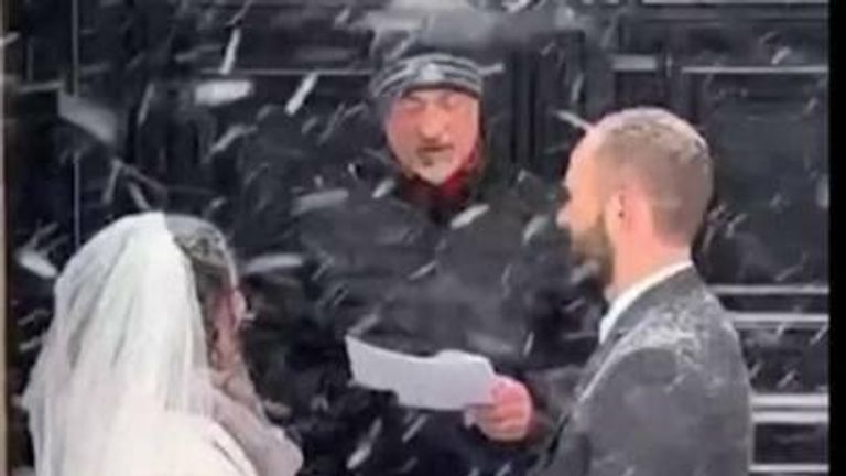 The US East Coast was hit with &#34;historic&#34; blizzards but that didn’t stop Sally and Adam Irujo from tying the knot outside as a Nor’easter brought more than 2ft of snow. 