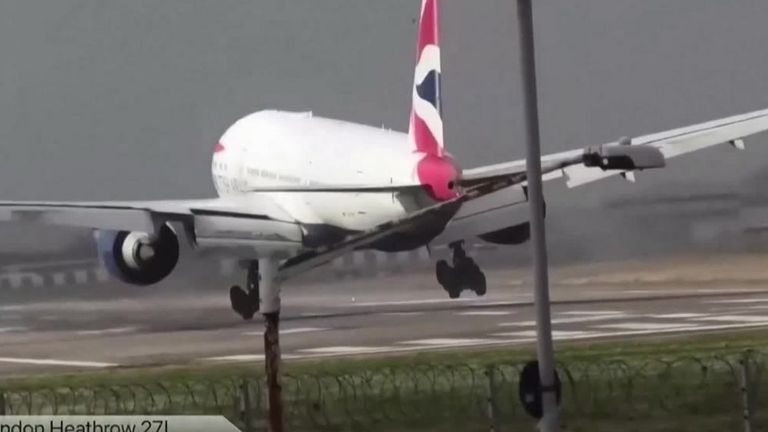 A plane struggles to land at Heathrow Airport as Storm Eunice winds strike London.