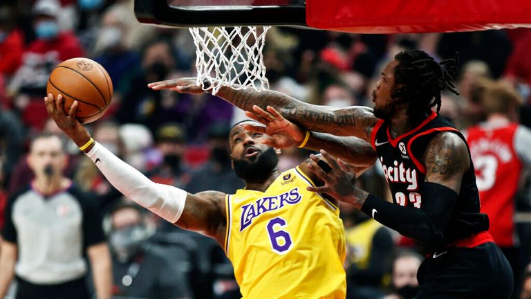 Los Angeles Lakers forward LeBron James, left, shoots as Portland Trail Blazers guard Ben McLemore, right, defends during the first half of an NBA basketball game in Portland, Ore., Wednesday, Feb. 9, 2022. (AP Photo/Steve Dipaola)