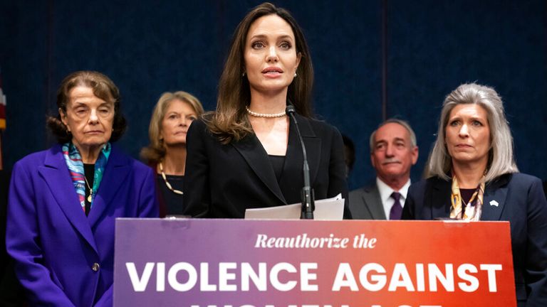 Actress and activist Angelina Jolie, center, is flanked by Sen. Dianne Feinstein, D-Calif., left, and Sen. Joni Ernst, R-Iowa, at a news conference to announce a bipartisan update to the Violence Against Women Act, at the Capitol in Washington, Wednesday, Feb. 9, 2022. (AP Photo/J. Scott Applewhite).                                                                                                                               
