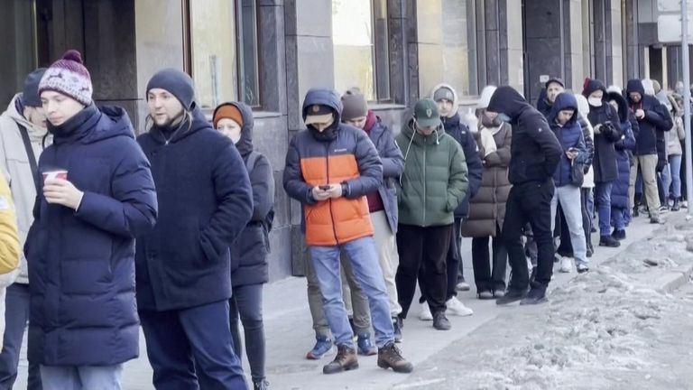 Queues form outside Russian ATMs as citizens as Western sanctions cause rouble to plunge in value.
