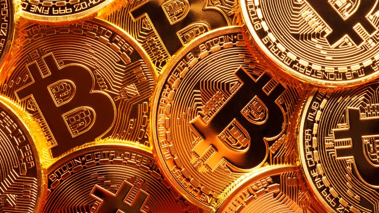 Poltics This is a pack up photo of plenty of gold plated bitcoins together symbolizing the bit coin market, usual skills, finance, net, buying and selling, etc.