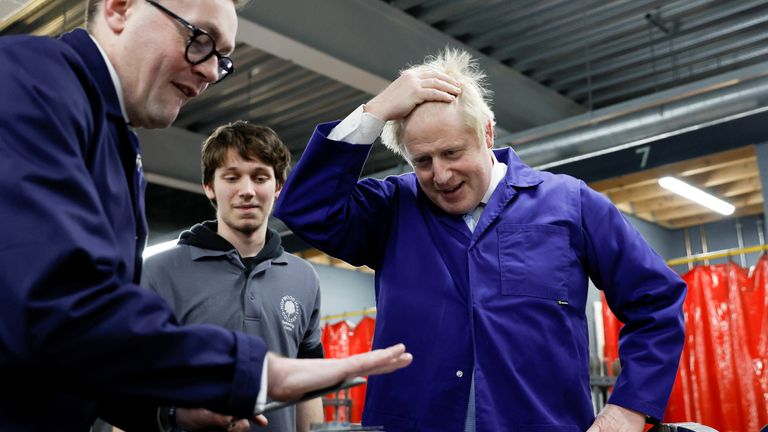 British Prime Minister Boris Johnson gestures at the technology centre at Hopwood Hall College, in Middleton, Greater Manchester, Britain, February 3, 2022. REUTERS/Jason Cairnduff/Pool
