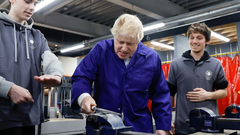 British Prime Minister Boris Johnson interacts with students at the technology centre at Hopwood Hall College, in Middleton, Greater Manchester, Britain, February 3, 2022. REUTERS/Jason Cairnduff/Pool
