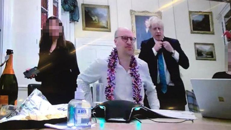 Copyright: Daily Mirror 
Boris Johnson with an open bottle of bubbly.
On the desk in front of him - from where he read out quiz questions to teams across the building - is what appears to be champagne and a half-eaten packet of crisps.
The image shows the Prime Minister flanked by three members of staff, one wearing tinsel and another a Santa hat (FAR RIGHT JUST IN SHOT), at the event on December 15, 2020.