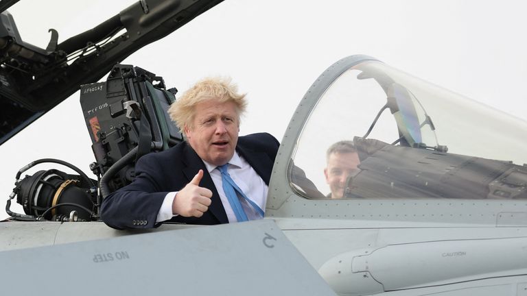 British Prime Minister Boris Johnson gestures from a military aeroplane during his visit at the Royal Air Force Station Waddington, in Waddington, Lincolnshire, Britain February 17, 2022. REUTERS/Carl Recine
