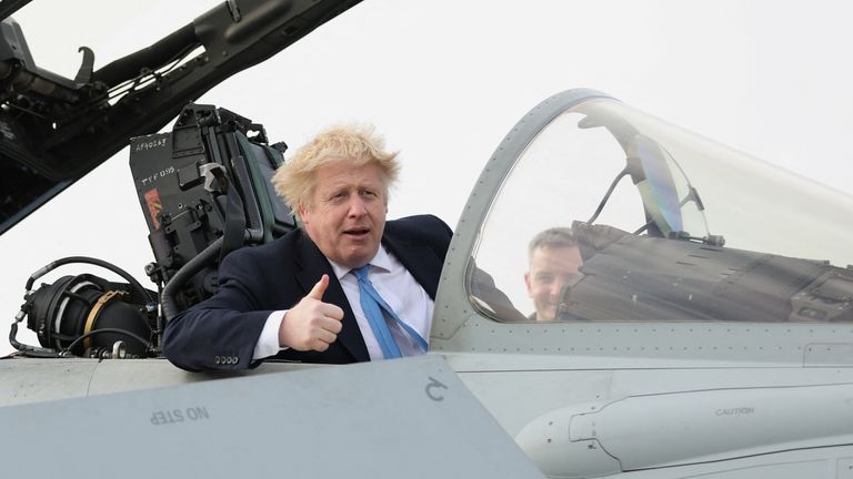 British Prime Minister Boris Johnson gestures from a military aeroplane during his visit at the Royal Air Force Station Waddington, in Waddington, Lincolnshire, Britain February 17, 2022. REUTERS/Carl Recine