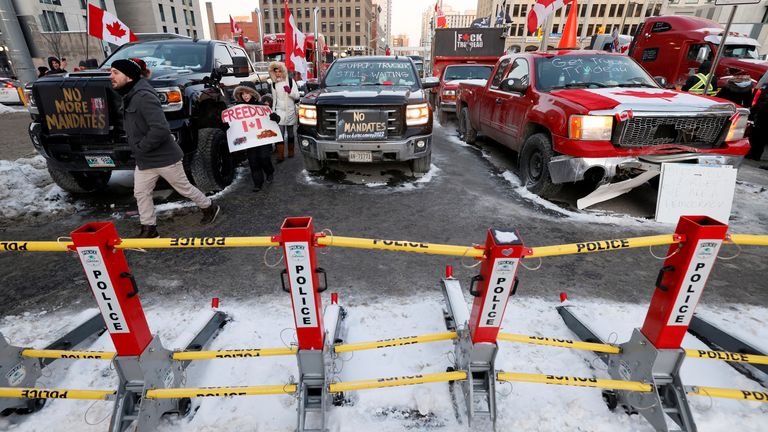 Trucks remain parked behind police barricades as truckers and supporters continue to protest coronavirus disease (COVID-19) vaccine mandates, in Ottawa, Ontario, Canada, February 5, 2022. REUTERS/Blair Gable
