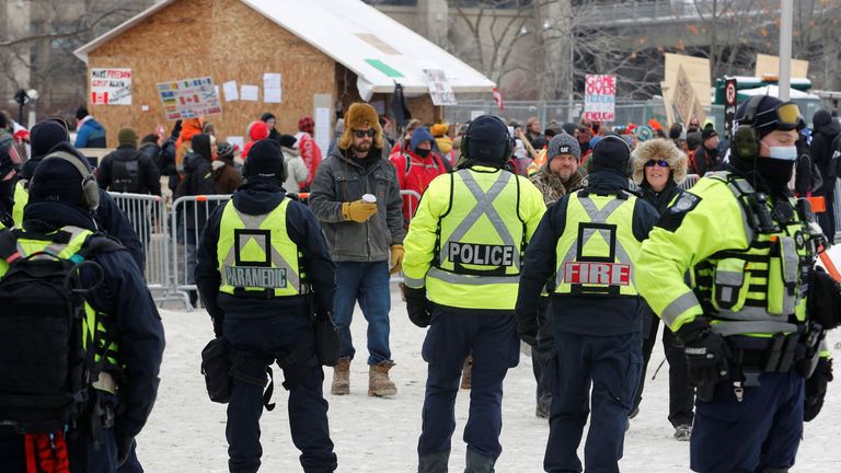 Police watch over a shack that was being used as a soup kitchen as truckers and their supporters continue to protest against the COVID-19 vaccine mandates
