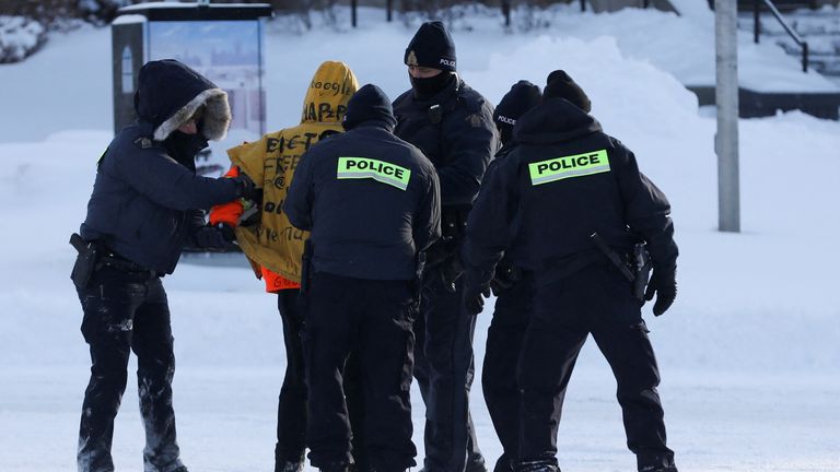 Police arrest a demonstrator during a protest against COVID-19 mandates on Friday, Feb. 18, 2022 in Ottawa. Police began arresting protesters Friday in a bid to break the three-week, traffic-snarling siege of Canada&#39;s capital by hundreds of truckers angry over the country&#39;s COVID-19 restrictions.(AP Photo/Robert Bumsted)


