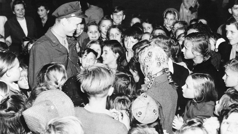 Berlin youngsters surround "Candy Bomber" Lt. Gail S. Halvorsen (left), an airlift pilot from Garland, Utah, at Tempelhof Airport, Berlin Oct. 8, 1948. Pic: AP