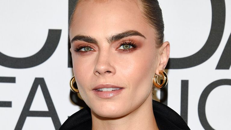 Cara Delevingne has said having an LGBTQ+ role model would have helped her be less ashamed
