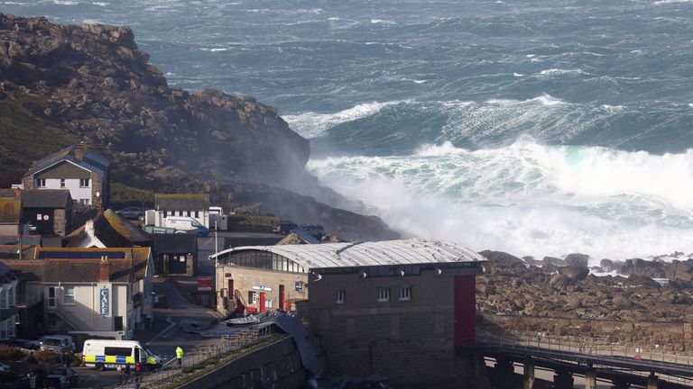 Waves crash over the lifeboat station, which was damaged by Storm Eunice, in Sennen Cove, Cornwall, Britain, February 18, 2022. REUTERS/Tom Nicholson
