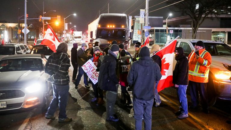 Protestors block the last entrance to the Ambassador Bridge, which connects Detroit and Windsor, effectively shutting it down as truckers and their supporters continue to protest against the coronavirus disease (COVID-19) vaccine mandates, in Windsor, Ontario, Canada February 9, 2022. REUTERS/Carlos Osorio
