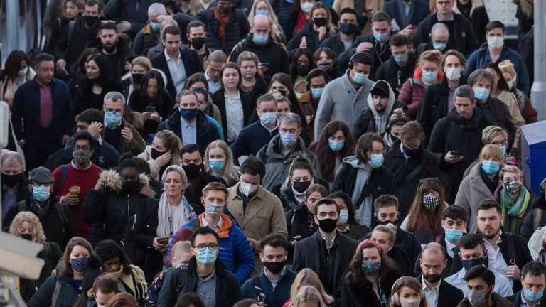 LONDON, UNITED KINGDOM - FEBRUARY 02, 2022: Commuters, some continuing to wear face masks, arrive at Waterloo station during morning rush hour on February 02, 2022 in London, England. The passenger numbers across the transport network have been increasing since relaxation of Covid-19 measures last week as workers and shoppers return to city centres. Yesterday, the UK recorded 112,458 new cases as reinfections were included in the official statistics for the first time.

