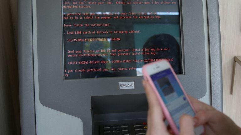 FILE PHOTO: A message demanding money is seen on a monitor of a payment terminal at a branch of Ukraine&#39;s state-owned bank Oschadbank after Ukrainian institutions were hit by a wave of cyber attacks earlier in the day, in Kyiv