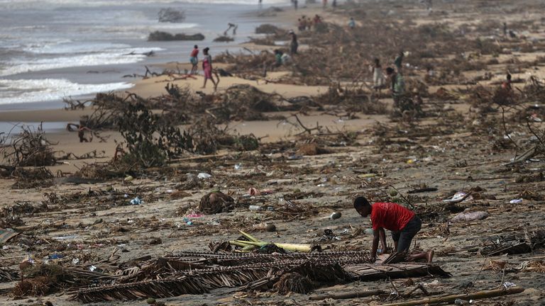 A boy searches among debris on the beach, in the aftermath of Cyclone Batsirai, in the town of Mananjary, Madagascar, February 8, 2022. REUTERS/Alkis Konstantinidis TPX IMAGES OF THE DAY