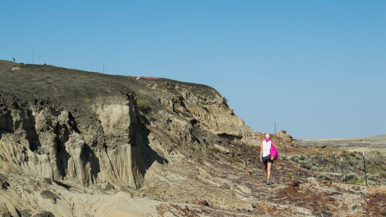 Melanie During pictured walking next to an embankment in southwestern North Dakota