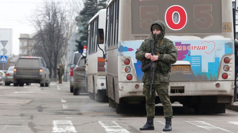 Militants of the self-proclaimed Donetsk People&#39;s Republic are seen next to buses arranged to transport local residents mobilized for military service, after Russian President Vladimir Putin authorized a military operation in eastern Ukraine, in the separatist-controlled city of Donetsk, Ukraine February 24, 2022. REUTERS/Alexander Ermochenko
