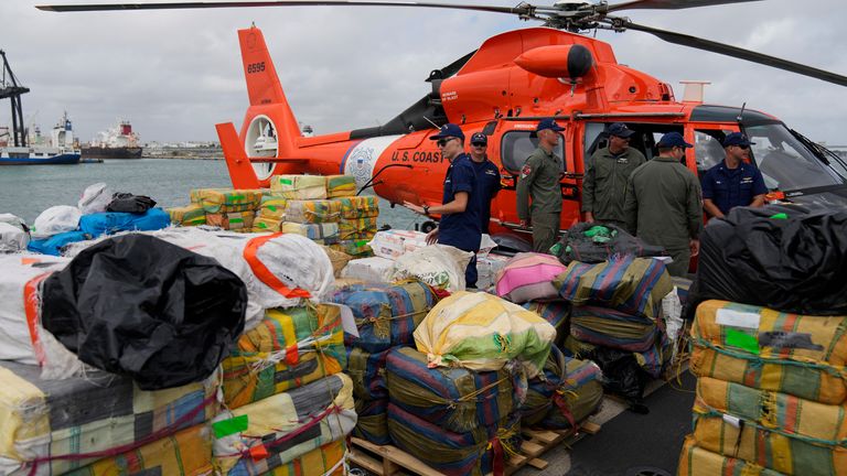 Members of the U.S. Coast Guard stand alongside bundles of seized cocaine and marijuana worth more than one billion dollars, aboard Coast Guard Cutter James at Port Everglades, Thursday, Feb. 17, 2022, in Fort Lauderdale, Fla. The Coast Guard said the haul included approximately 54,500 pounds of cocaine and 15,800 pounds of marijuana from multiple interdictions in the Caribbean Sea and the eastern Pacific. (AP Photo/Rebecca Blackwell)


