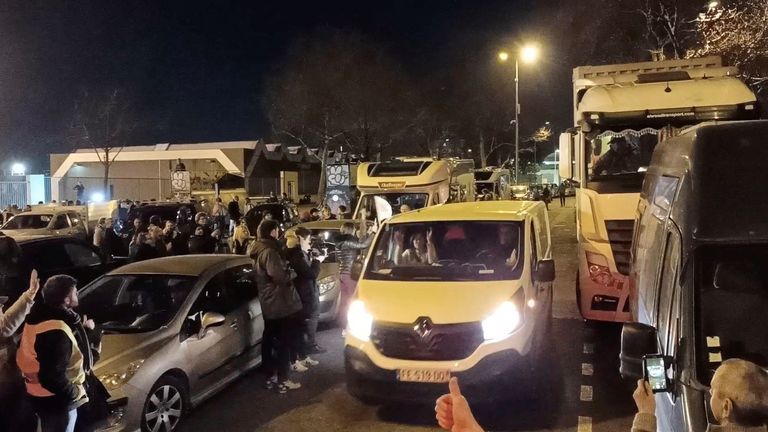 Supporters wave flags and cheer as truck and car drivers, part of a &#39;freedom convoy&#39; on its way to Paris, arrive in Lyon, France February 10, 2022 in this still image taken from a video obtained from a social media. Video taken February 10, 2022. Gabriel Bonnaveira/via REUTERS THIS IMAGE HAS BEEN SUPPLIED BY A THIRD PARTY. MANDATORY CREDIT. NO RESALES. NO ARCHIVES.
