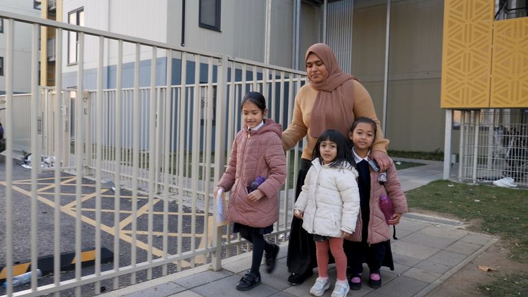Alifjane Begum and her three children, outside her temporary accommodation in Dagenham