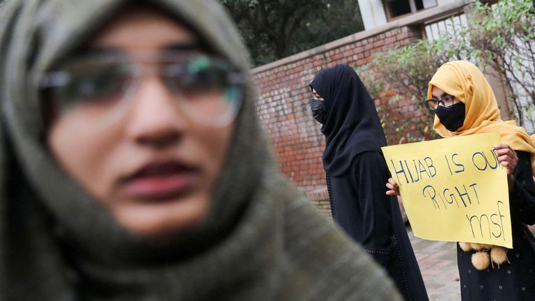 A Muslim student holds a placard during a protest by Muslim Students Federation (MSF) against the recent hijab ban in few of Karnataka&#39;s colleges, in New Delhi, India, February 8, 2022. REUTERS/Anushree Fadnavis
