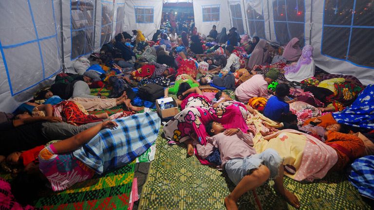 Earthquake survivors sleep inside a tent at a temporary shelter in Pasaman Barat, West Sumatra, Indonesia. 2. (AP Photo/Ardhy Fernando)