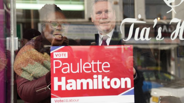 Labour leader Keir Starmer putting up a sign at Tia&#39;s Hair Salon during a visit to Erdington in Birmingham to support Labour&#39;s by-election candidate Paulette Hamilton and speak about the Respect pillar of his contract with the British people. Picture date: Wednesday February 16, 2022.

