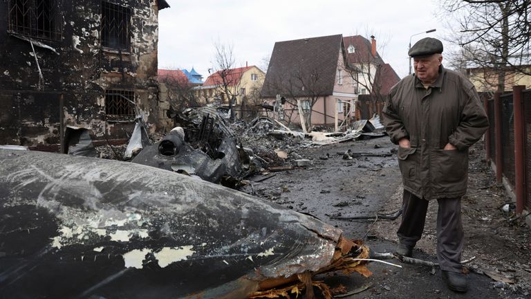 A person walks around the wreckage of an unidentified aircraft that crashed into a house in a residential area, after Russia launched a massive military operation against Ukraine, in Kyiv, Ukraine February 25, 2022. REUTERS/Umit Bektas
