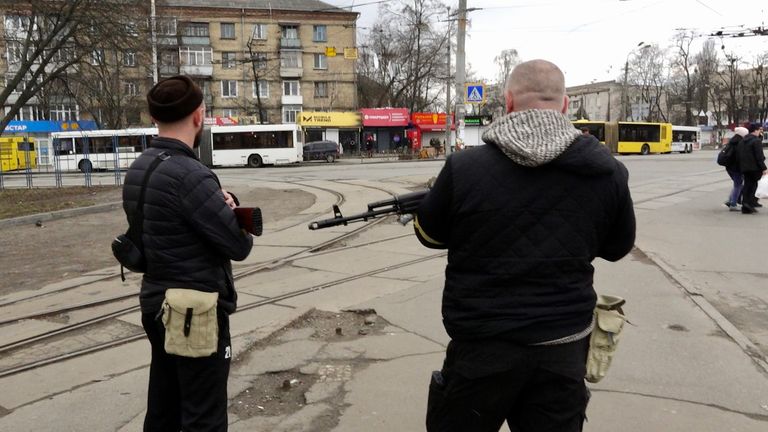 Armed civilian militia patrol the streets of Kyiv
