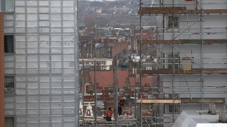Contractors remove cladding from a building in Paddington, London