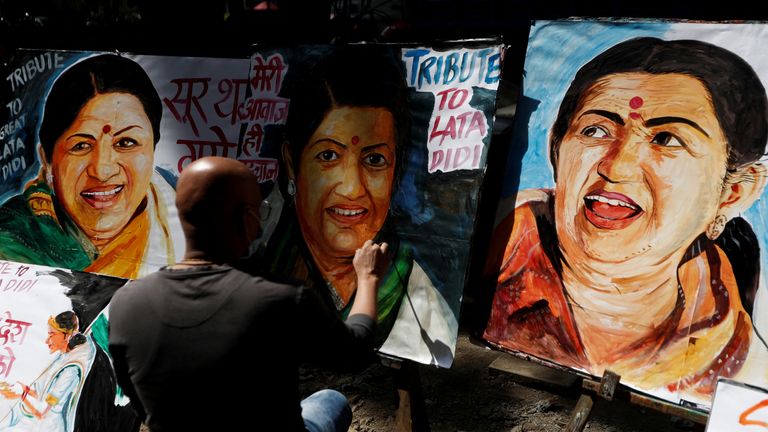 An artist paints a tribute to late Indian singer and music composer Lata Mangeshkar