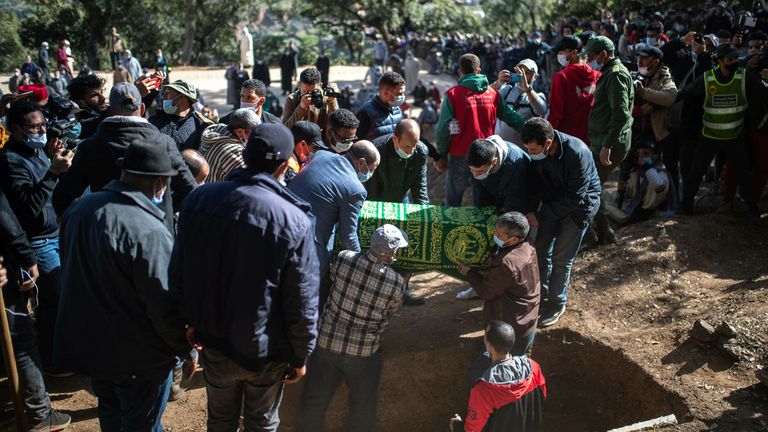 The coffin of 5-year-old Rayan is lowered into a grave during his funeral after his body was retrieved from a deep well, in the village of Ighran in Morocco&#39;s Chefchaouen province, Monday, Feb. 7, 2022. Five-year-old Rayan was pulled dead from a 32-meter (105 foot) deep dry well where he was trapped for five days. (AP Photo/Mosa&#39;ab Elshamy)