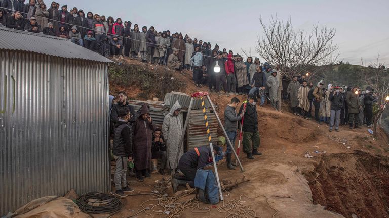 Residents watch in concern as civil defense and local authorities dig in a hill as they attempt to rescue a 5 year old boy who fell into a hole near the town of Bab Berred near Chefchaouen, Morocco, Thursday, Feb. 3, 2022. (AP Photo)