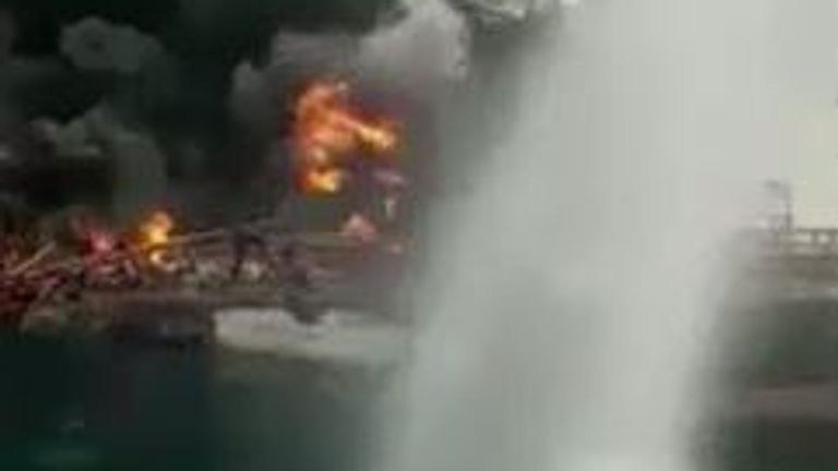 Footage appears to show water being sprayed on the fire from another vessel