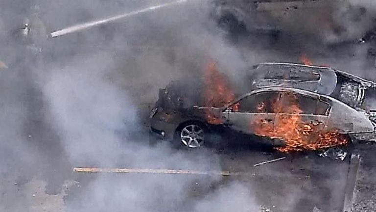 A grass fire destroyed nine cars in Oklahoma City after spreading from a  major highway. Pictures: KFOR