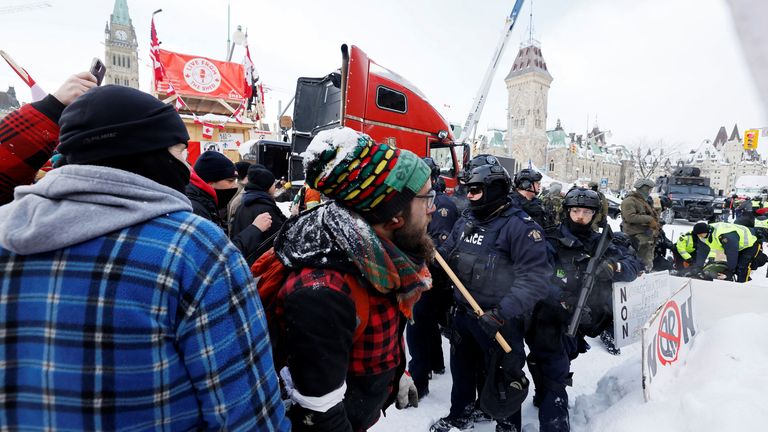 Canadian police officers face off with protestors, as they work to restore normality to the capital while trucks and demonstrators continue to occupy the downtown core for more than three weeks to protest against pandemic restrictions in Ottawa, Ontario, Canada, February 19, 2022. REUTERS/Blair Gable